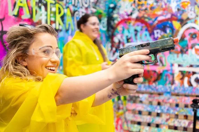 Guests shooting paint at a spinning canvas